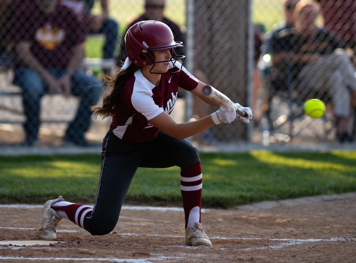 Gibson Southern's Ally Malone (4) drops a bunt against Memorial during their 2023 Class 3A Softball Sectional at Gibson Southern Wednesday evening, May 25, 2023.