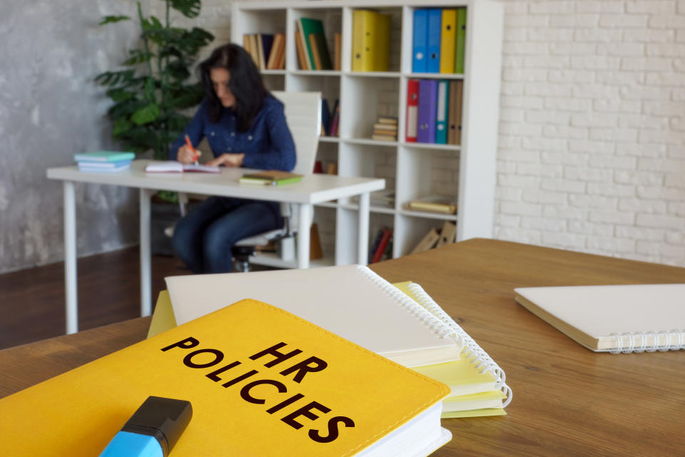 Book titled "HR Policies" on a desk