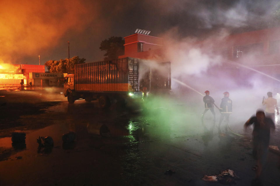 Firefighters work to contain a fire that broke out at the BM Inland Container Depot, a Dutch-Bangladesh joint venture, in Chittagong, 216 kilometers (134 miles) southeast of capital, Dhaka, Bangladesh, early Sunday, June 5, 2022. Several people were killed and more than 100 others were injured in the fire the cause of which could not be immediately determined. (AP Photo)