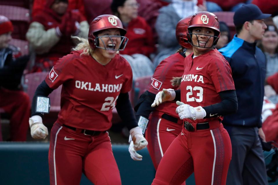 OU's Tiare Jennings (23) scores a run as Jayda Coleman (24) celebrates in the second inning of an 8-0 win against South Dakota State on March 13 at Marita Hynes Field in Norman.