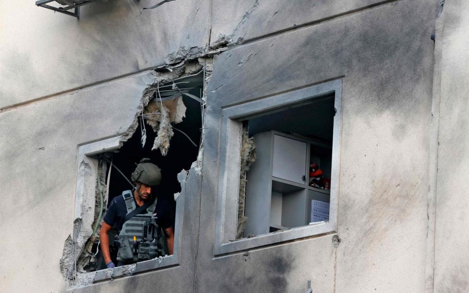 An Israeli sapper checks a damaged apartment in the southern Israeli city of Ashkelon