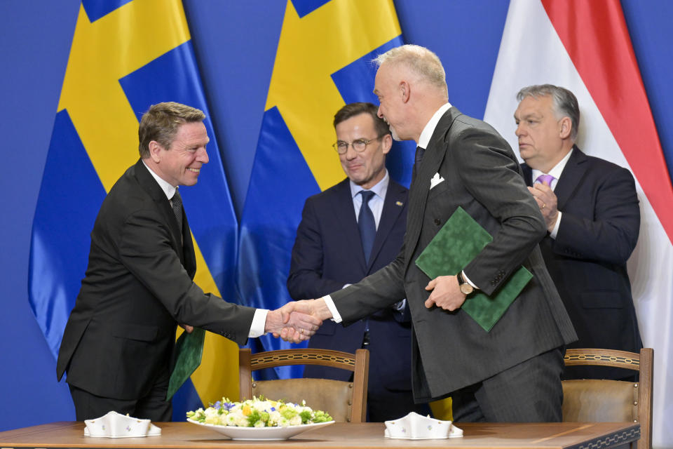 Director General of the Swedish Defence Materiel Administration Goran Martensson, left, shakes hands with Hungarian Minister of Defence Kristof Szalay-Bobrovniczky after signing a defense industry agreement at the Carmelite Monastery in Budapest, Hungary, Friday, Feb 23, 2024. Nearly two years after Sweden formally applied to join NATO, its membership now hinges on convincing one country - Viktor Orban's Hungary - to formally ratify its bid to join the military alliance. (AP Photo/Denes Erdos)