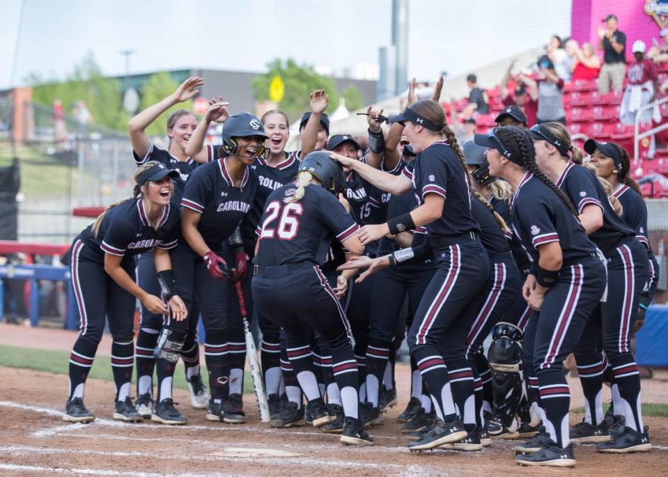 South Carolina Gamecocks infielder Riley Blampied (26) is swarmed by her team after hitting a home run during a quarterfinal game May 11 against the Georgia Bulldogs in the SEC Softball Tournament.