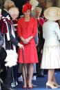 <p>The Duchess wears a bright red Catherine Walker coat dress accessorized with a matching headpiece at the Order of the Garter Service at Windsor Castle.</p>