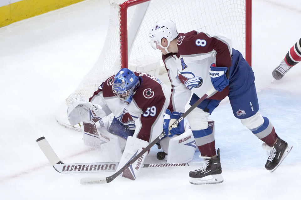 Colorado Avalanche goaltender Pavel Francouz makes a save as Cale Makar also defends during the first period of an NHL hockey game against the Chicago Blackhawks Thursday, Jan. 12, 2023, in Chicago. (AP Photo/Charles Rex Arbogast)