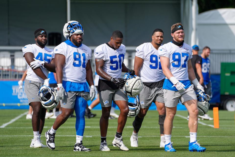 Defensive Lineman Issac Ukwu, Levi Onwuzurike, LB Mitchell Agude, Marcus Davenport and Aidan Hutchinson walk off the field during day two of the Detroit Lions training camp at the Detroit Lions Headquarters in Dearborn, Mich. on Thursday, July 25, 2024.