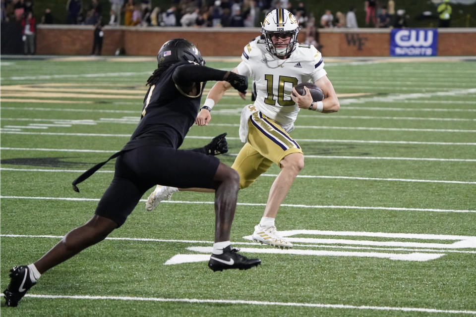 Georgia Tech quarterback Haynes King (10) tries to run past Wake Forest defensive back Caelen Carson (1) during the second half of an NCAA college football game in Winston-Salem, N.C., Saturday, Sept. 23, 2023. (AP Photo/Chuck Burton)