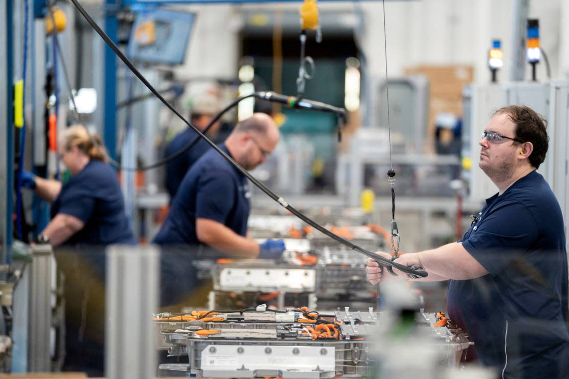 Employees work in the battery assembly hall at the BMW Spartanburg plant in Greer, S.C., Wednesday, Oct. 19, 2022. BMW’s sprawling factory near Spartanburg, will get a $1 billion investment, and the German automaker will spend another $700 million to build a battery plant nearby as it begins the transition to electric vehicles in the U.S., the company announced. (AP Photo/Sean Rayford)