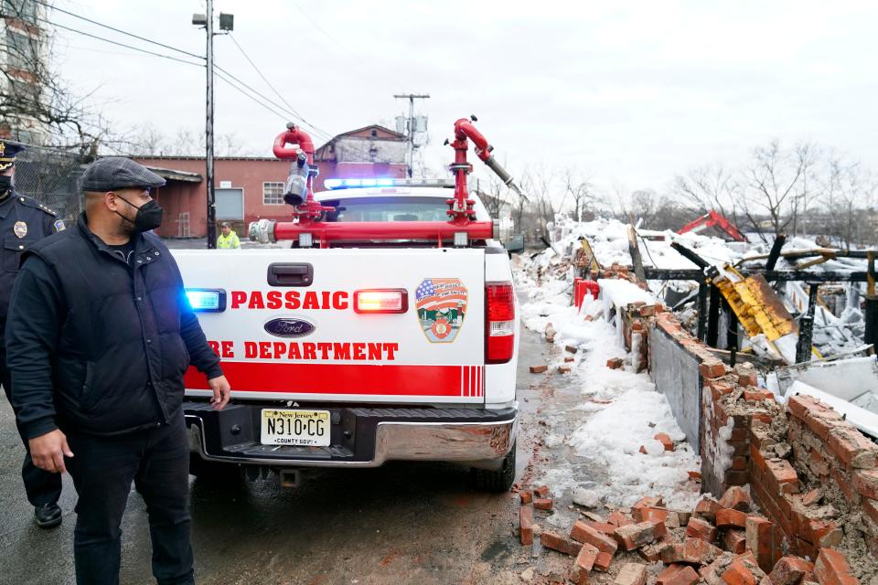 Passaic Mayor Hector Lora looks over the damage in the aftermath of an 11-alarm fire that destroyed much of the Qualco chemical plan in Passaic on Monday, Jan. 17, 2022.