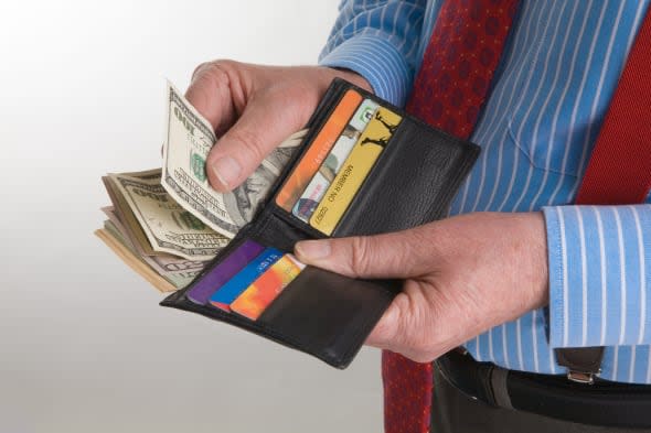Man with wallet full of dollars