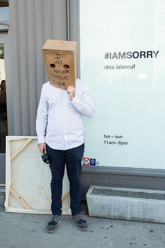 Shia LaBeouf with a paper bag over his head outside his #IAMSORRY art installation