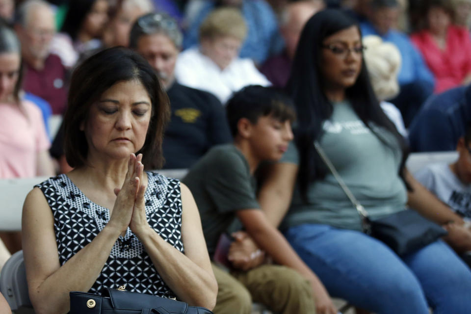 Mira Marquez, of Midland, Texas, folds her hands in prayer during a prayer service, Sunday, Sept. 1, 2019, in Odessa, Texas, for the victims of a shooting spree the day before. (AP Photo/Sue Ogrocki)