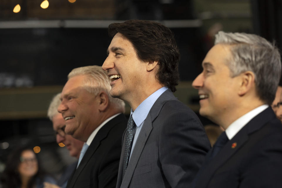 Prime Minister Justin Trudeau, center, Ontario Premier Doug Ford ,left,and Industry Minister Francois-Philippe Champagne attend an announcement on a Volkswagen electric vehicle battery plant at the Elgin County Railway Museum in St. Thomas, Ontario, Friday, April 21, 2023. (Tara Walton/The Canadian Press via AP)