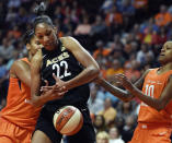 FILE - In this May 20, 2018, file photo, Las Vegas Aces forward A'ja Wilson (22) tries to get a rebound between Connecticut Sun forward Alyssa Thomas, left, and guard Courtney Williams during a WNBA basketball game in Uncasville, Conn. Las Vegas will have a lot of their hometown players to root for at the WNBA All-Star Game on July 27. Reigning rookie of the year A’ja Wilson is one of the team captains. She’ll be joined by Aces teammates Liz Cambage and Kayla McBride in the starting lineup. (Sean D. Elliot/The Day via AP, File)