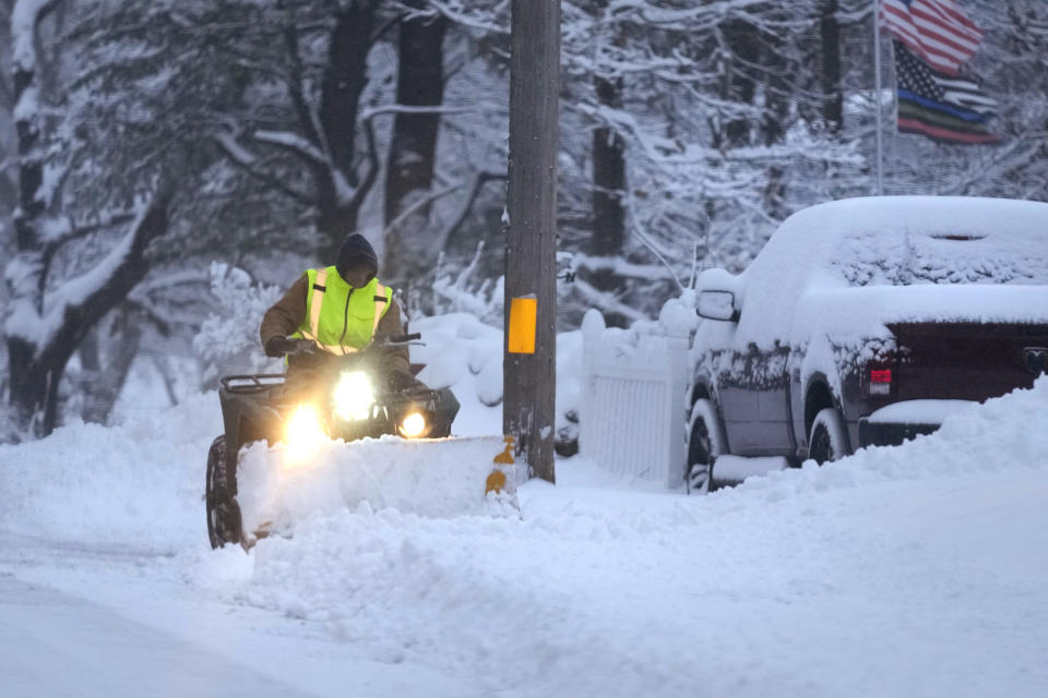 A man plows a snow covered driveway, Sunday, Jan. 7, 2024, in Derry, N.H. Some areas of New England are expected to receive about a foot of snow from a winter storm. (AP Photo/Charles Krupa)