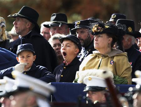 A young Union Civil War re-enactor (C) yawns at the Gettysburg National Cemetery in Pennsylvania November 19, 2013, the burial ground for Civil War Union soldiers in which U.S. President Abraham Lincoln travelled to in 1863 to deliver a few concluding remarks at a formal dedication. REUTERS/Gary Cameron