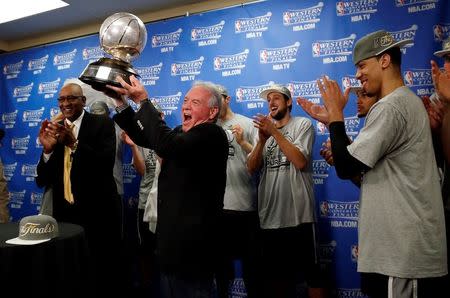 May 31, 2014; Oklahoma City, OK, USA; San Antonio Spurs chairman Peter Holt holds up the Western Conference championship trophy after his team defeated the Oklahoma City Thunder in game six of the Western Conference Finals of the 2014 NBA Playoffs at Chesapeake Energy Arena. San Antonio won 112-107. Mandatory Credit: Sue Ogrocki-Pool Photo via USA TODAY Sports