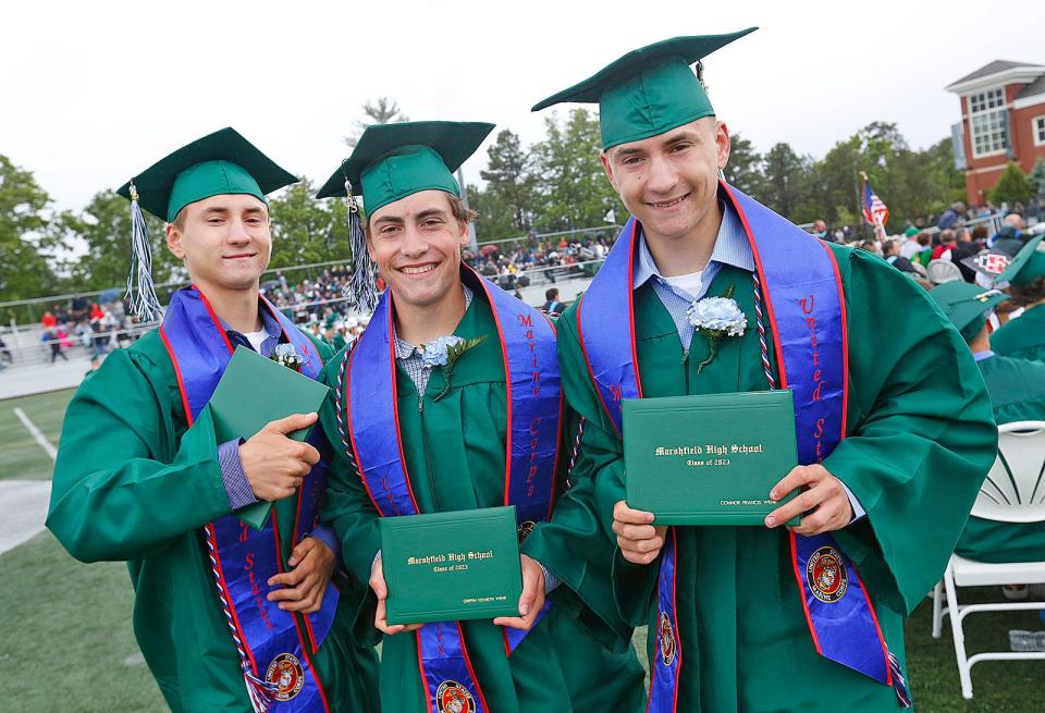 The Wehr triplets -- Matthew, Griffin and Connor, all of whom have enlisted in the U.S. Marine Corps -- hold their diplomas.