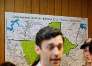 <p>A district map hangs behind Democratic candidate for 6th congressional district Jon Ossoff as he talks to supporters during a stop at a campaign office in Chamblee, Ga., Monday, June 19, 2017. (Photo: David Goldman/AP) </p>