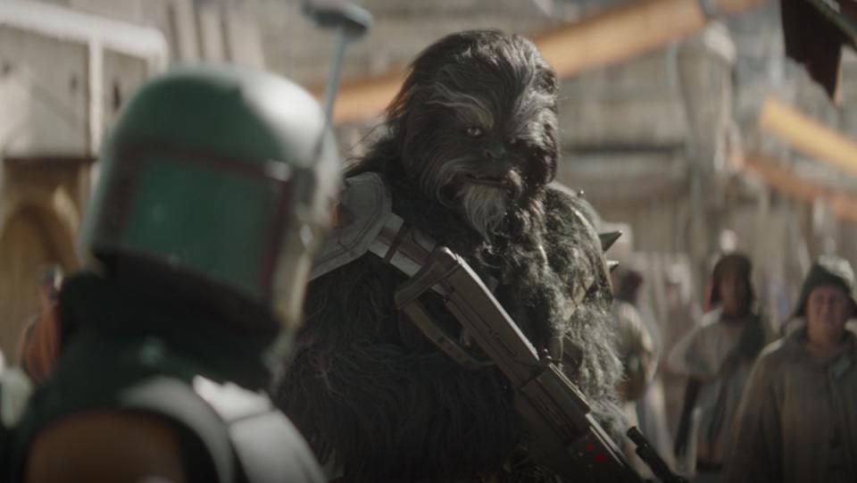 The wookiee bounty hunter Black Krrsantan stares at Boba Fett