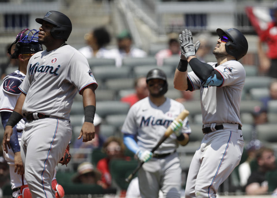 Miami Marlins' Adam Duvall, right, celebrates after hitting a three-run home run off Atlanta Braves' Charlie Morton during the sixth inning of a baseball game Sunday, July 4, 2021, in Atlanta. (AP Photo/Ben Margot)