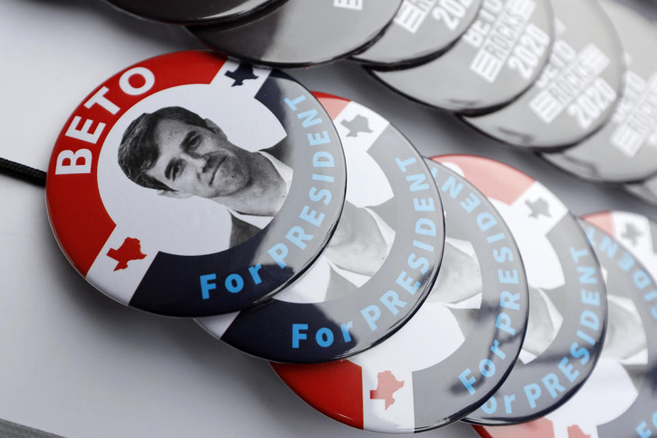 FILE - In this March 15, 2019, file photo, buttons for Democratic presidential candidate former Texas congressman Beto O'Rourke sit on display during a stop at the Central Park Coffee Company in Mount Pleasant, Iowa. O’Rourke entered the 2020 presidential race in mid-March as a political phenomenon, addressing overflow crowds around the country in off-the-cuff ways. Now, with that buzz cooling, O'Rourke is preparing a planned "re-introduction" that will see him do more national television appearances and concentrate on producing a series of detailed policy proposals. (AP Photo/Charlie Neibergall, File)