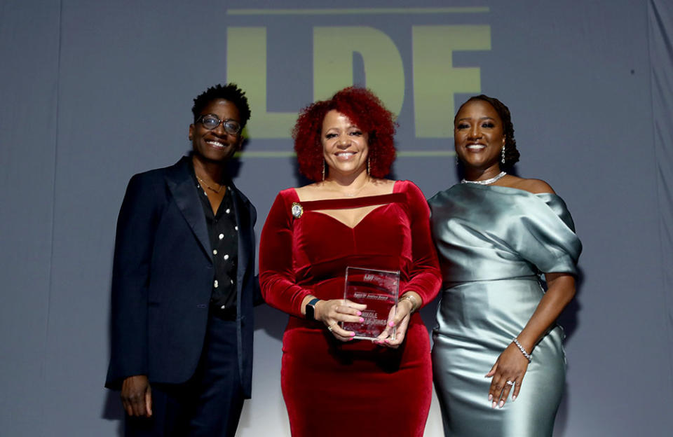 Nikole Hannah-Jones (C) accepts the Spirit of Justice award from Jackie Woodson (L) and president and director-counsel of the NAACP Legal Defense Fund Janai S. Nelson (R) - Credit: Bennett Raglin/Getty Images