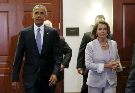 U.S. President Barack Obama, with House Democratic leader Nancy Pelosi (R) at his side, walks from a meeting room after making a last-ditch appeal to House Democrats to support a package of trade bills vital to his Asian policy agenda in the U.S. Capitol in Washington June 12, 2015. REUTERS/Kevin Lamarque