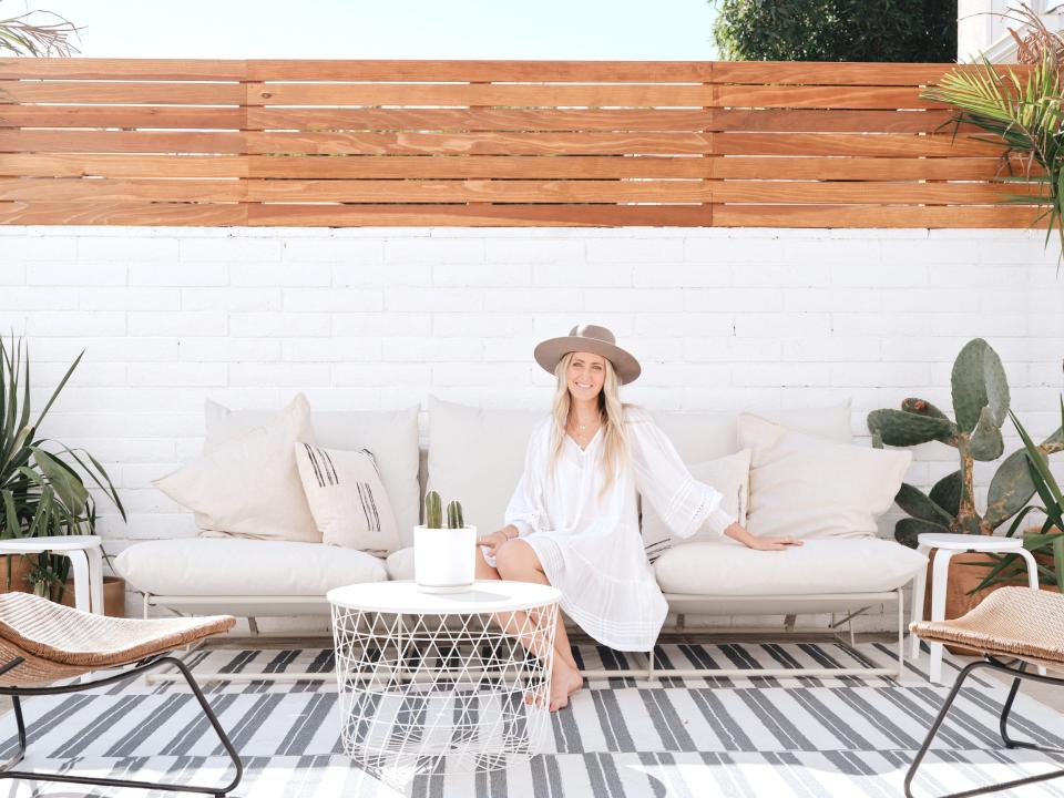 Laura Genevieve sitting on the outdoor couch.