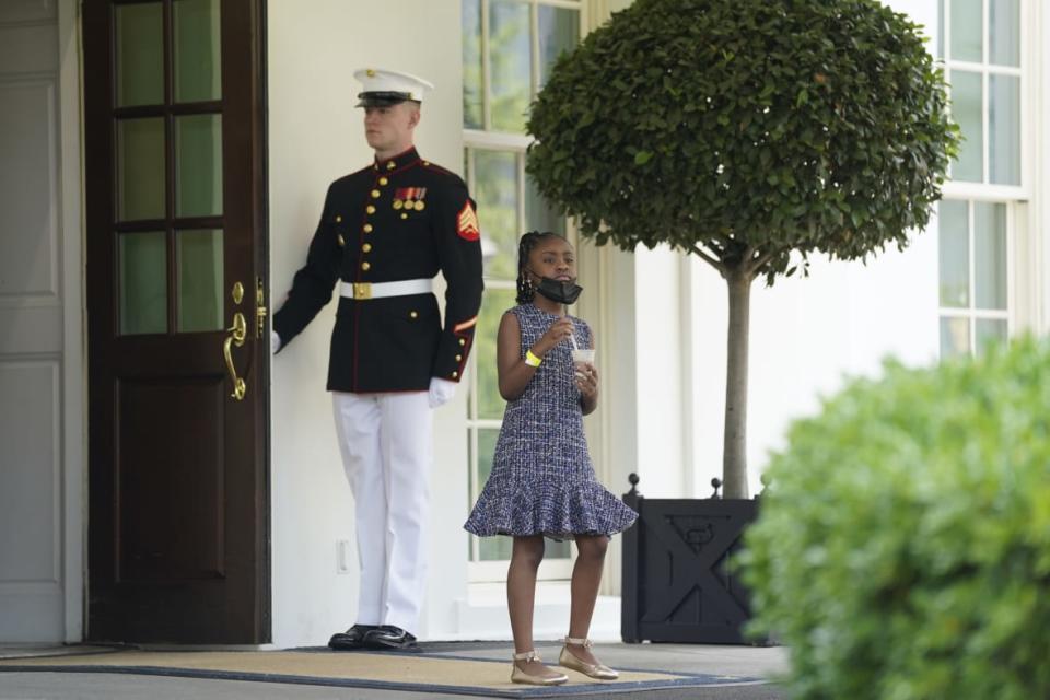 A guard holds the door on May 25, 2021 as Gianna Floyd, the daughter of George Floyd, walks out of the West Wing of the White House in Washington, D.C. Several Floyd family members met with President Joe Biden and Vice President Kamala Harris. (AP Photo/Evan Vucci, File)