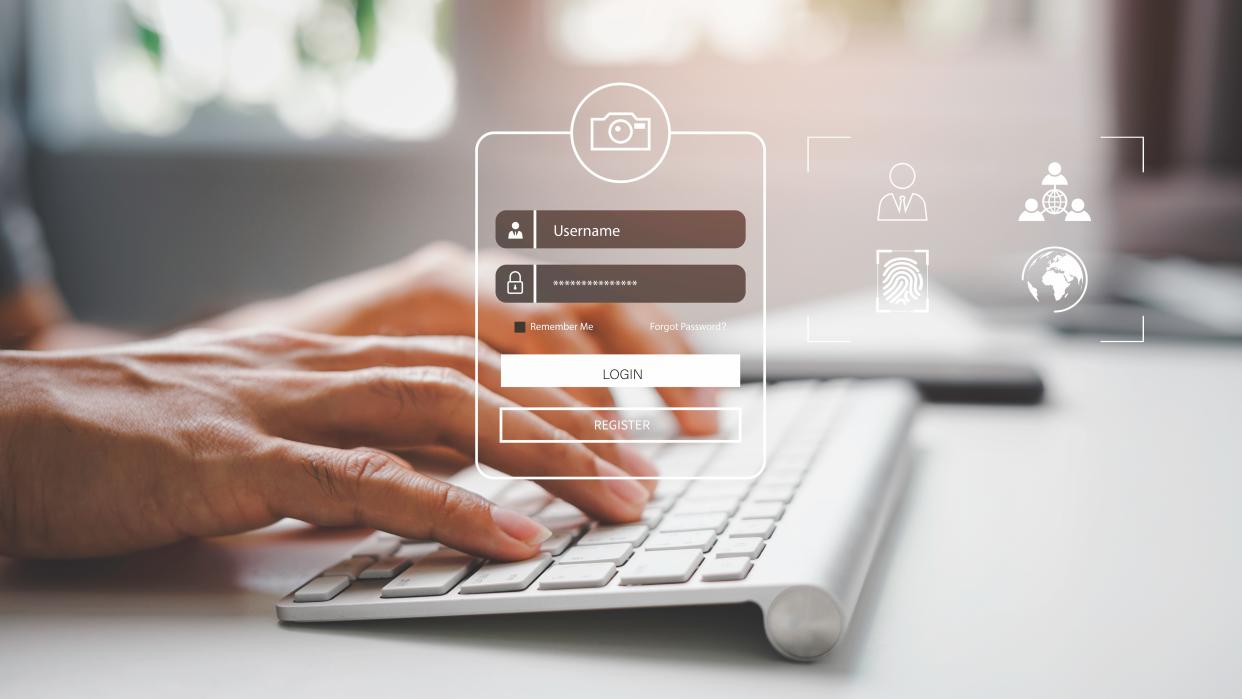  Hands typing on a Mac keyboard overlaid with a transparent login dialog box. 