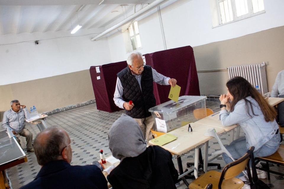 A voter casts his ballot at a polling station in Istanbul, Turkey in the second round of presidential elections. (Yusuf Sayman/For The Independent)