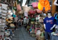 People walk past shops in the Medina, in the Old City of Tunis