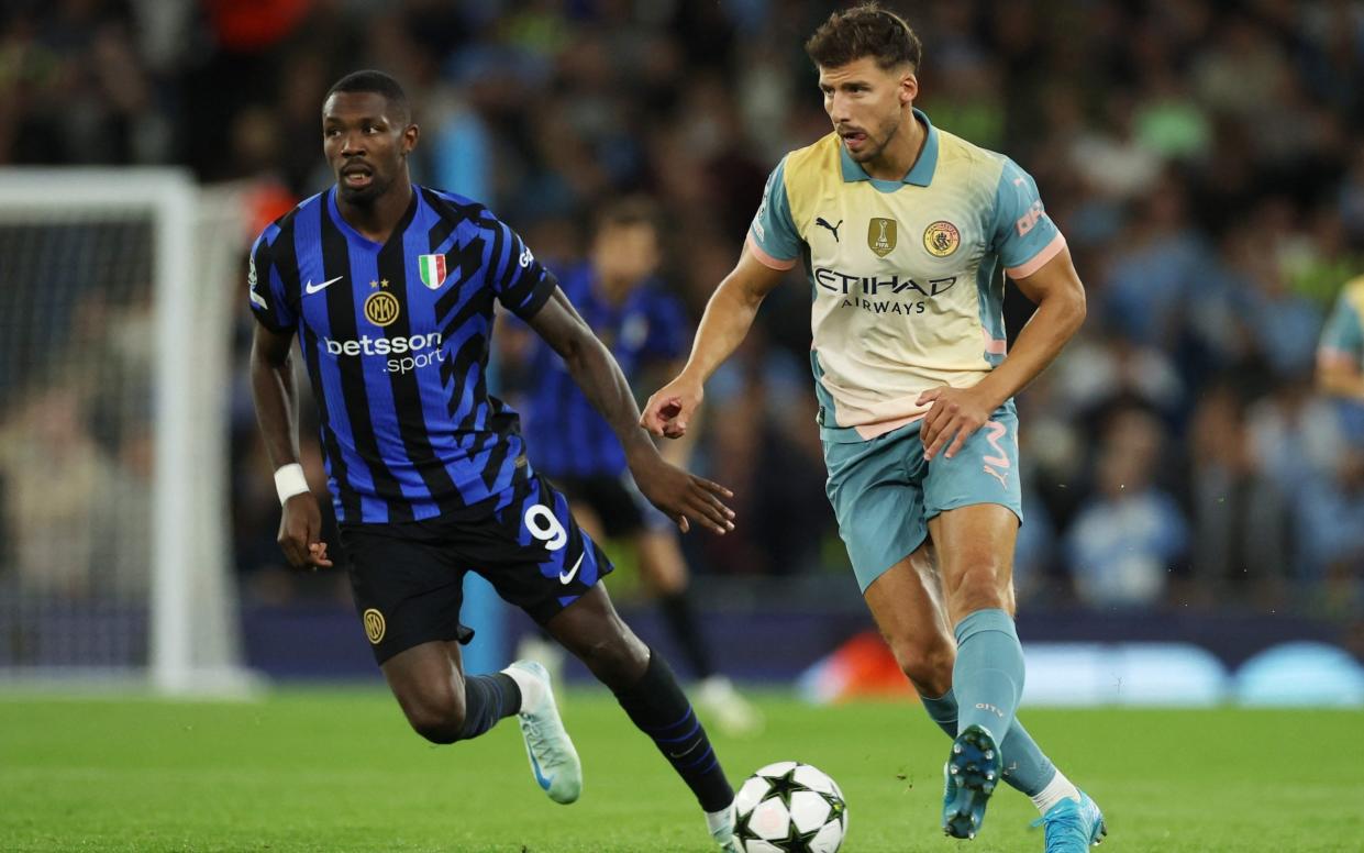 Inter Milan's Marcus Thuram in action with Manchester City's Ruben Dias