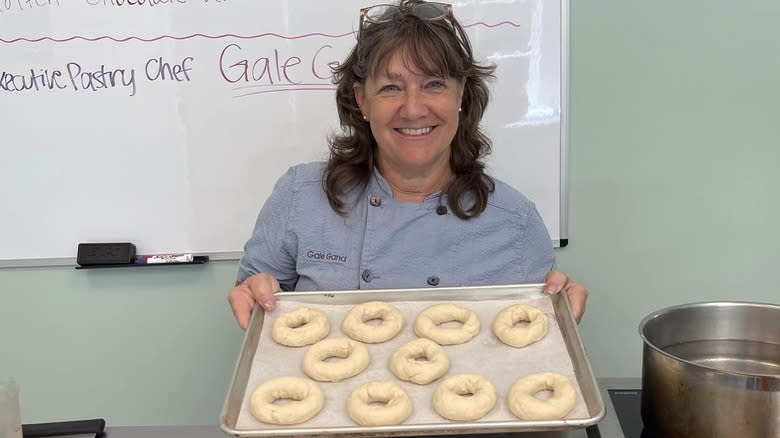 Gale Gand holding a tray of uncooked bagels