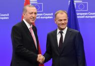 Turkey's President Recep Tayyip Erdogan (L) is welcomed by European Council President Donald Tusk in Brussels, on October 5, 2015