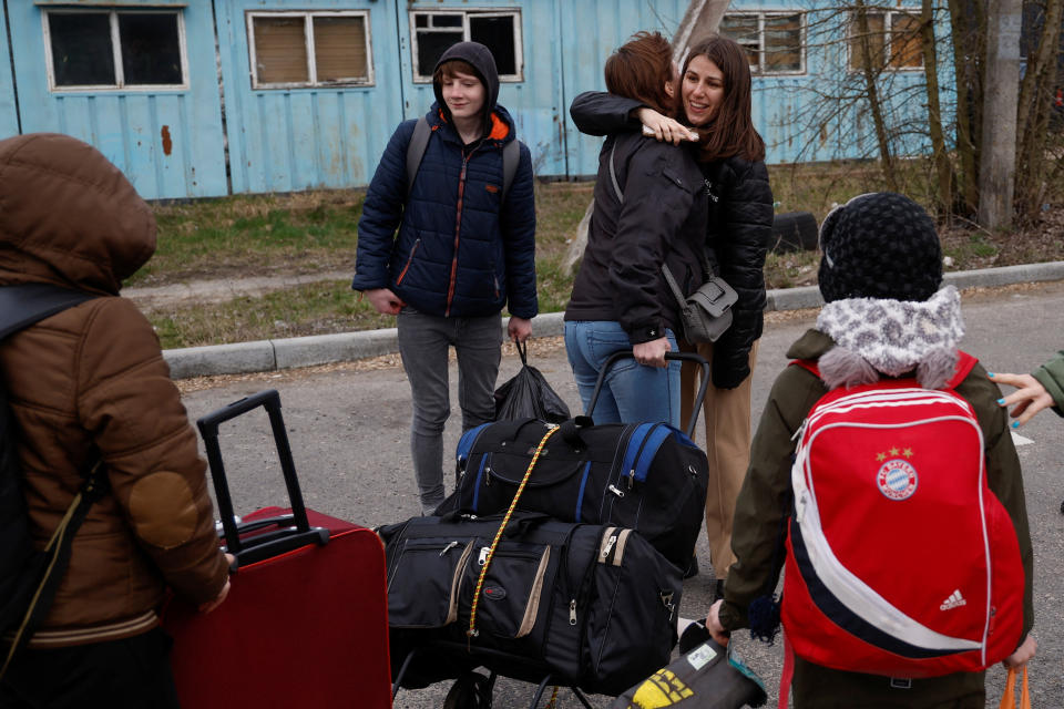 'Save Ukraine' volunteer Kateryna embraces Natalia after she returned with children, who went to a Russian-organised summer camp from non-government controlled territories and were then taken to Russia, at the Ukraine-Belarus border in Volyn region, Ukraine April 7, 2023. REUTERS/Valentyn Ogirenko