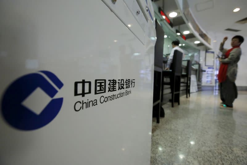 A customer waits at a counter of a branch of China Construction Bank Corp (CCB) at its headquarters in Beijing, China