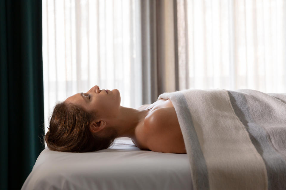 A woman laying down for a massage as part of the Reset trekking retreat in Telluride, Colorado