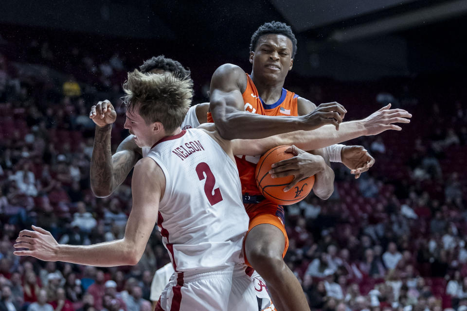 Clemson forward RJ Godfrey rebounds against Alabama forward Grant Nelson (2) during the first half of an NCAA college basketball game, Tuesday, Nov. 28, 2023, in Tuscaloosa, Ala. (AP Photo/Vasha Hunt)