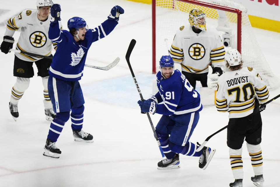 Toronto Maple Leafs' John Tavares (91) and Matthew Knies (23) celebrate after a goal against Boston Bruins goaltender Jeremy Swayman, top right, as Bruins' Jesper Boqvist (70) looks on during second-period action in Game 6 of an NHL hockey Stanley Cup first-round playoff series in Toronto, Thursday, May 2, 2024. (Frank Gunn/The Canadian Press via AP)
