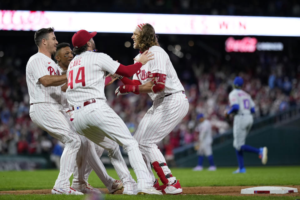 Philadelphia Phillies' Alec Bohm celebrates with teammates after hitting the game-winning run-scoring single against New York Mets pitcher Adam Ottavino during the 10th inning of a baseball game, Friday, Sept. 22, 2023, in Philadelphia. (AP Photo/Matt Slocum)