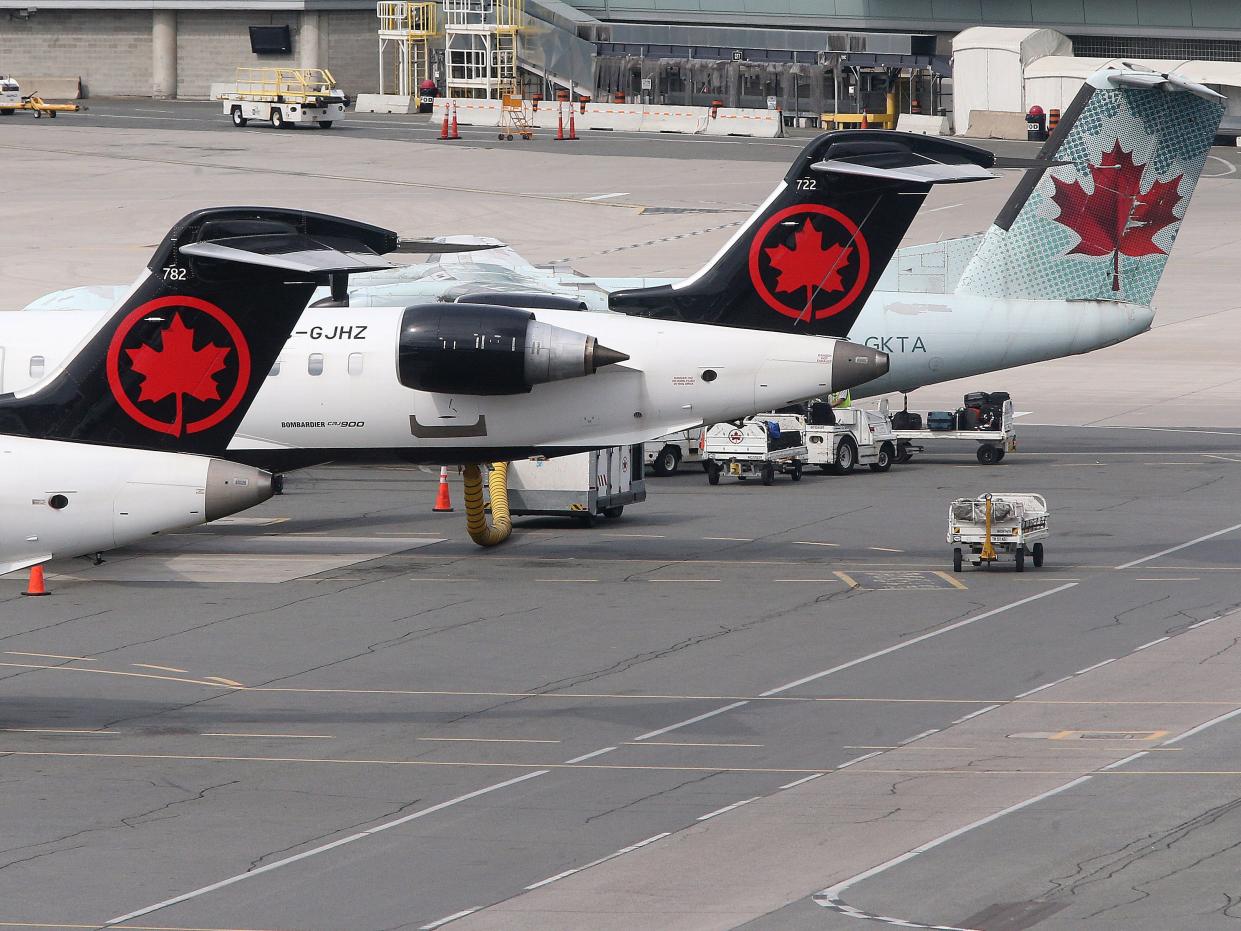 Air Canada planes sit on the tarmac at the airport. Passengers arriving on international flights go through COVID-19 testing at terminal 3 at Toronto Pearson International Airport in Toronto. September 25, 2021.