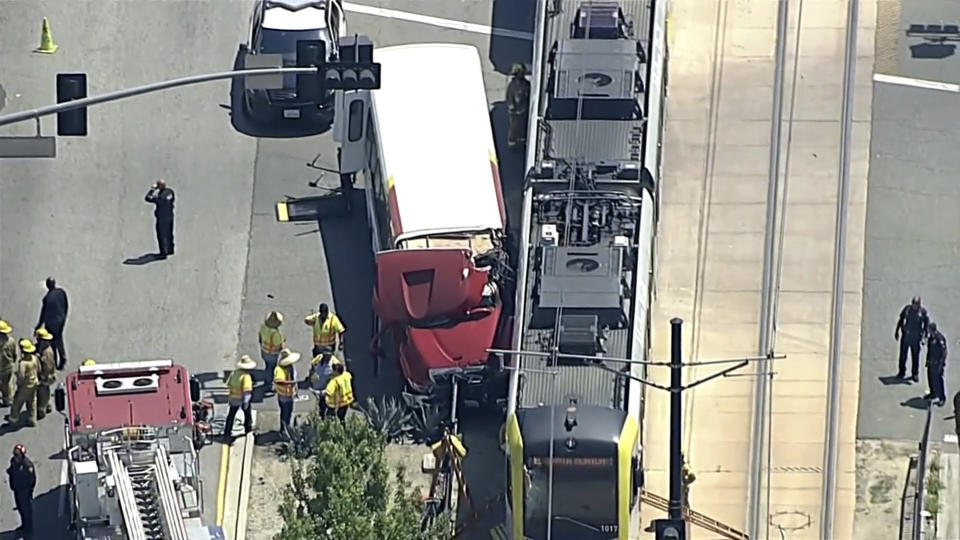 In this aerial still image provided by KABC-TV, firefighters respond to the scene of an accident where a shuttle bus collided with a Metro light rail train on Tuesday, April 30, 2024, in Los Angeles. (KABC via AP)