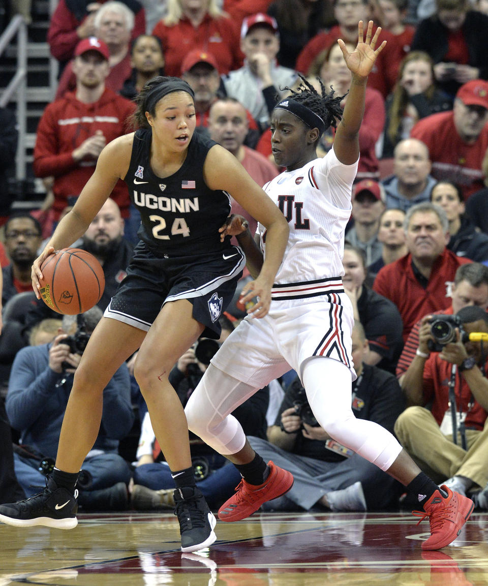 Connecticut forward Napheesa Collier (24) attempts to get position on Louisville guard Jazmine Jones during the second half of an NCAA college basketball game in Louisville, Ky., Thursday, Jan. 31, 2019. Louisville won 78-69. (AP Photo/Timothy D. Easley)