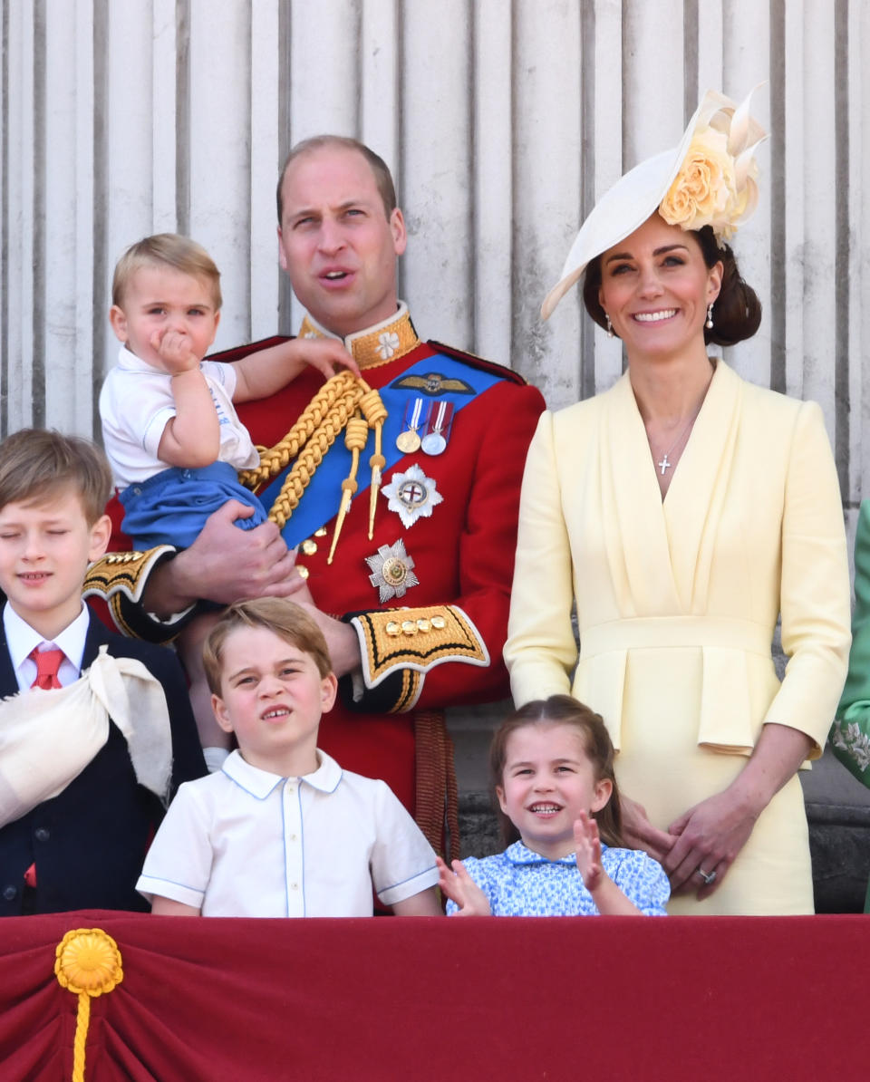 The Duchess of Cambridge wore a sunny yellow Alexander McQueen dress with peplum detailing at the waist for Trooping the Colour. She teamed it with a matching floral hat by Philip Treacy and the Queen's Bahrain pearl and diamond earrings. [Photo: PA]