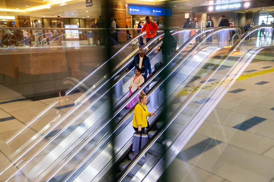 Travelers walk through Phoenix Sky Harbor International Airport in Phoenix on Nov.18, 2023.