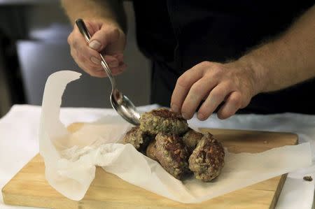 A chef prepares "Kibbeh", also known as Syrian meatballs, in the kitchen of the Castro restaurant in Budapest, Hungary, September 29, 2015. REUTERS/Bernadett Szabo