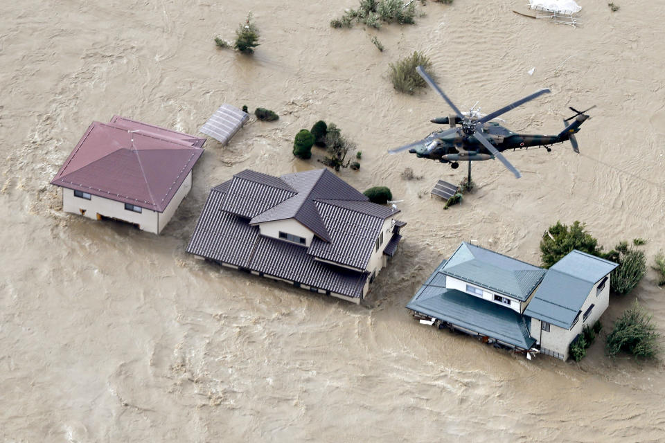 A Japan Self-Defense Forces helicopter hovers above a submerged residential area after an embankment of the Chikuma River broke because of Typhoon Hagibis, in Nagano, central Japan, Oct. 13, 2019. (Photo: Yohei Kanasashi/Kyodo News via AP)