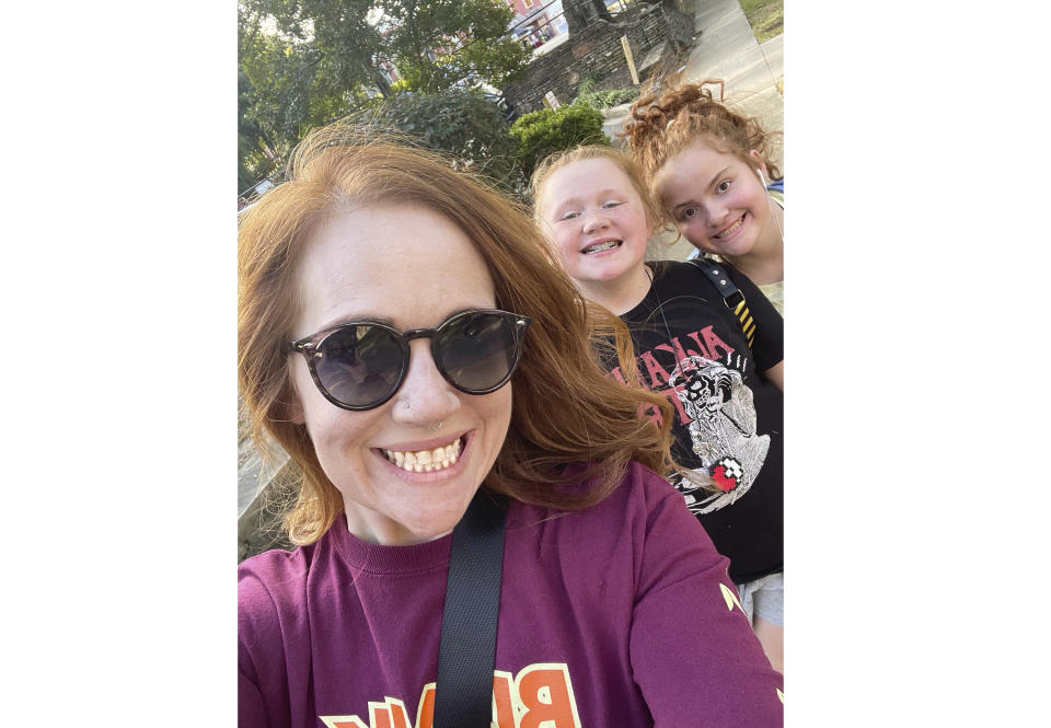 This photo shows Micah Woods with her daughters, 10-year-old Emilynn Dodd, center, and 11-year-old Eleanor Dodd in Little Rock, Ark., on Oct. 22, 2022. After hours dealing with glitches and long waits on Ticketmaster, Woods was unable to buy Taylor Swift concert tickets for her kids. (Micah Woods via AP)